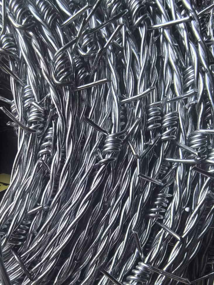 Galvanised barbed wire coils in the factory